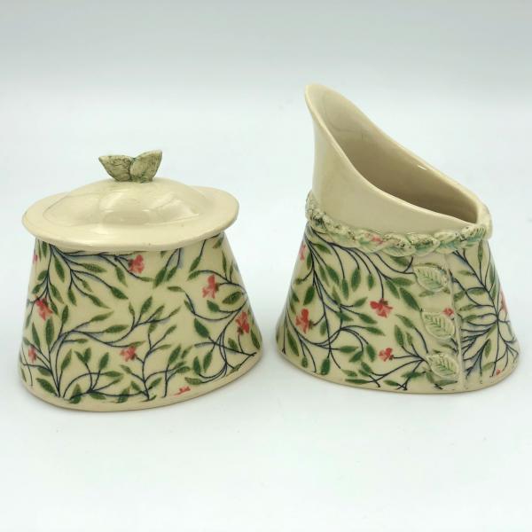 Ceramic sugar bowl and cream pitcher in adorable floral pattern