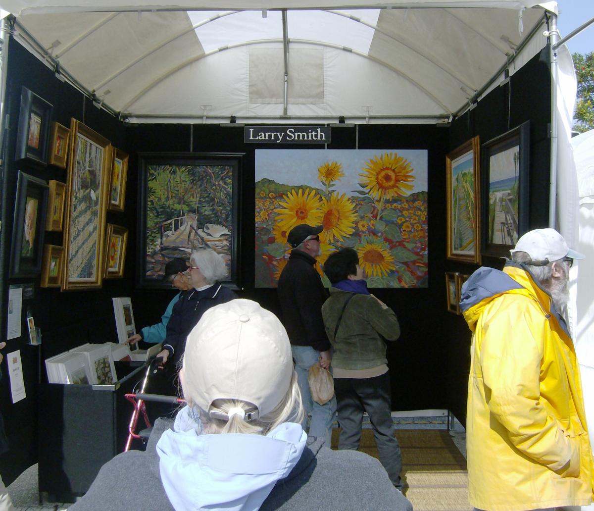 Artist observing visitors in a booth