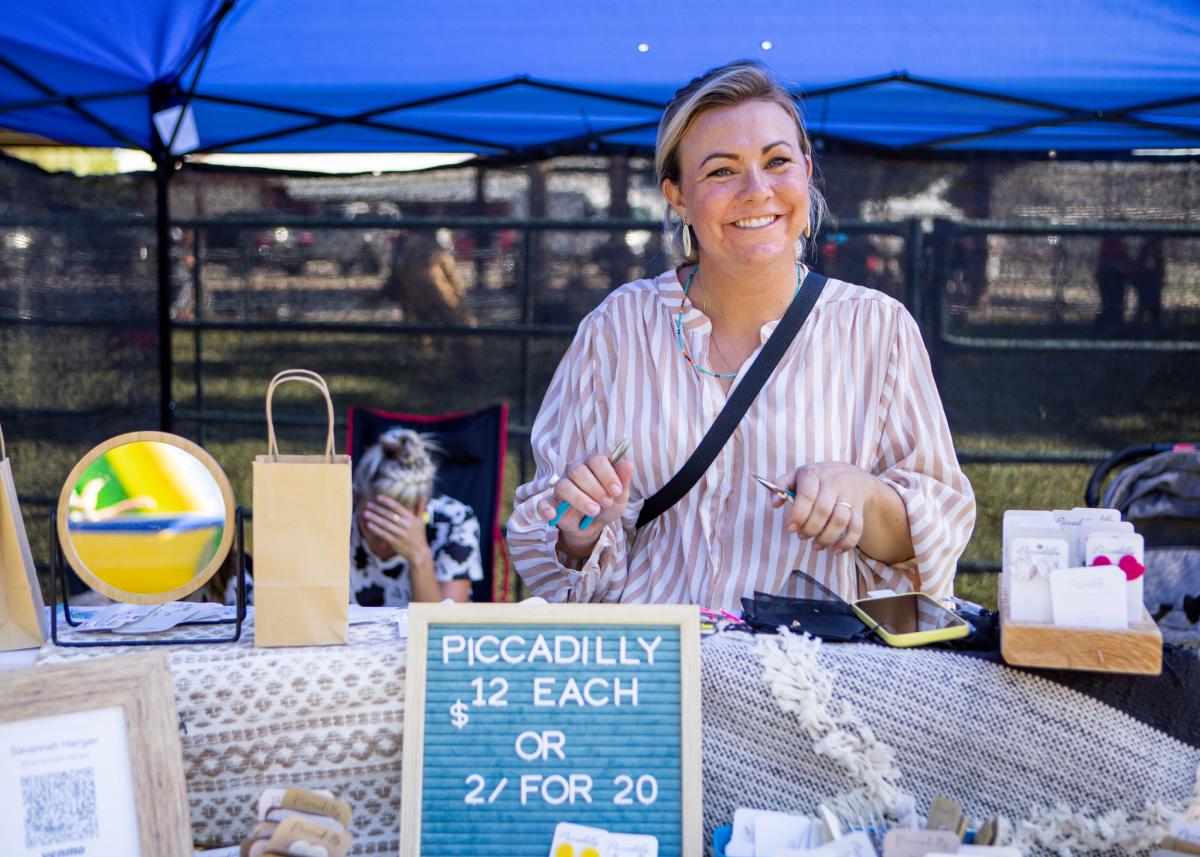 Vendor showcasing her homemade earrings