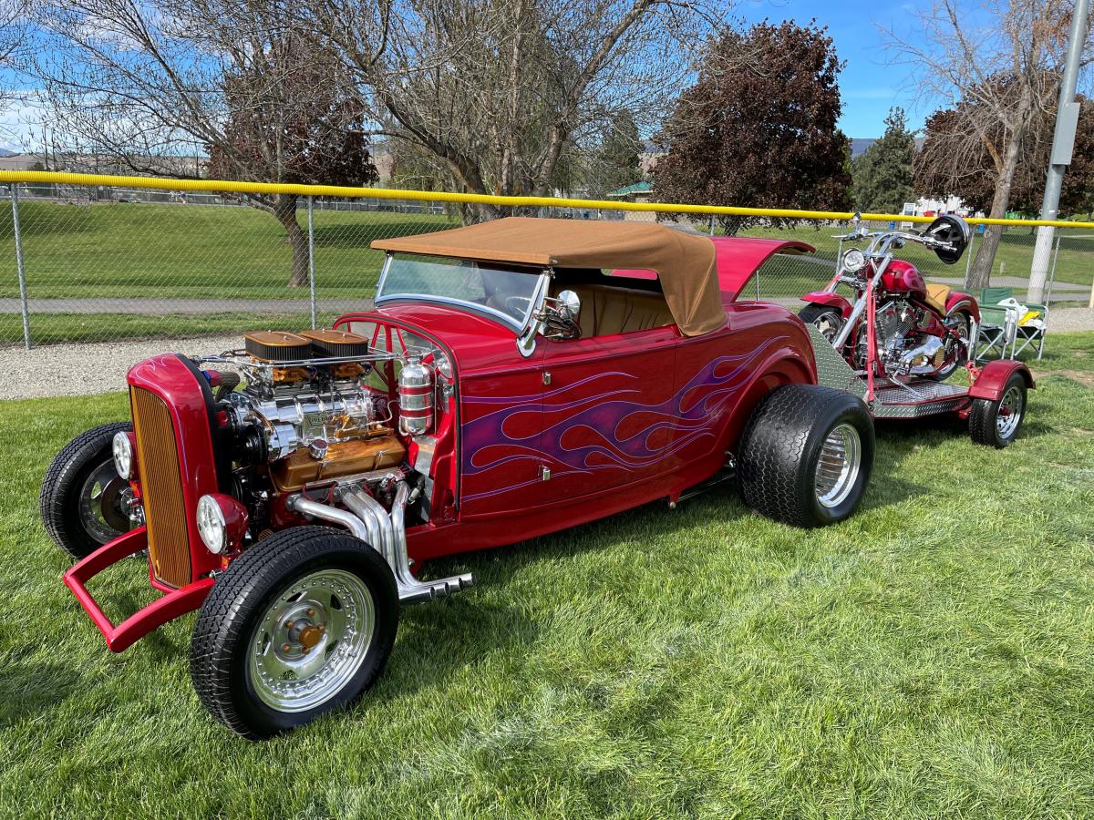 Vintage maroon, High Boy with a matching motorcycle on a trailer.