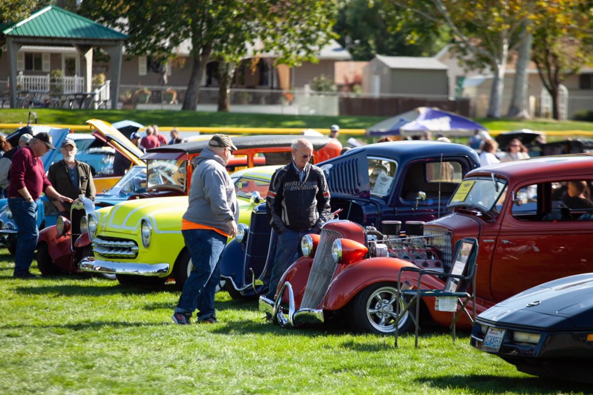 Vintage cars parked side-by-side on grass.