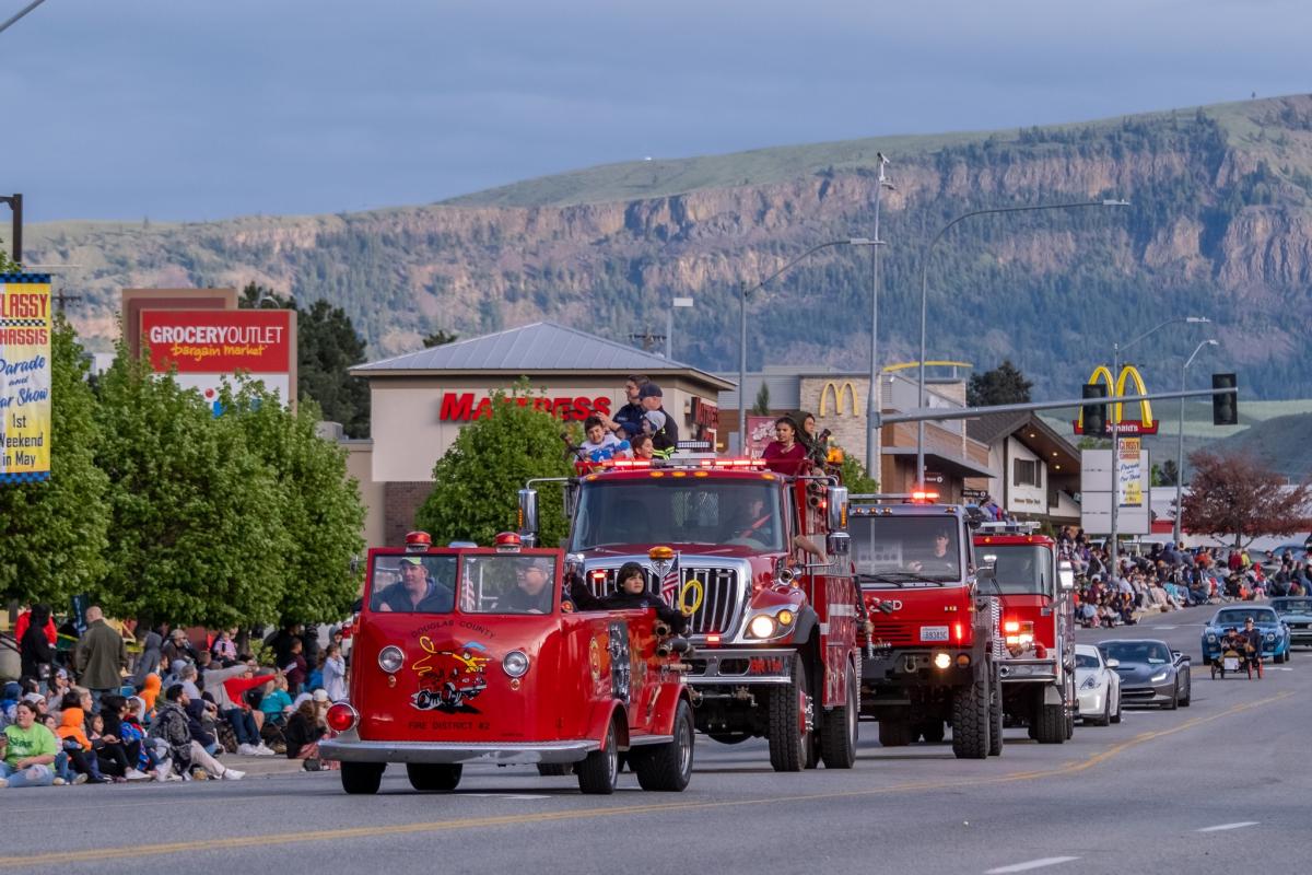 Fire trucks driving in a line, during the Classy Chassis Parade.