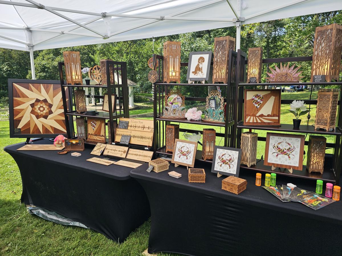 A vendor's booth with art on shelves