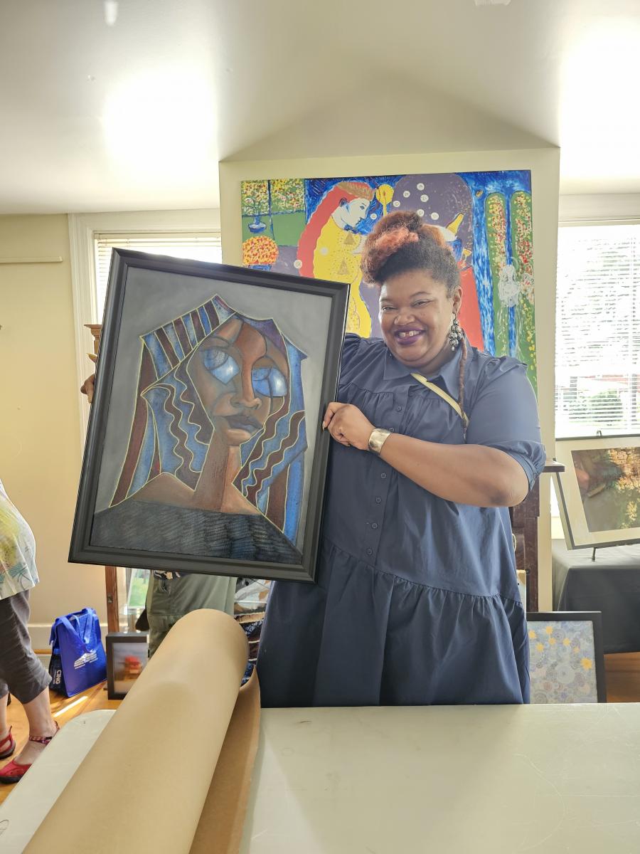 Happy woman shows the painting she just bought