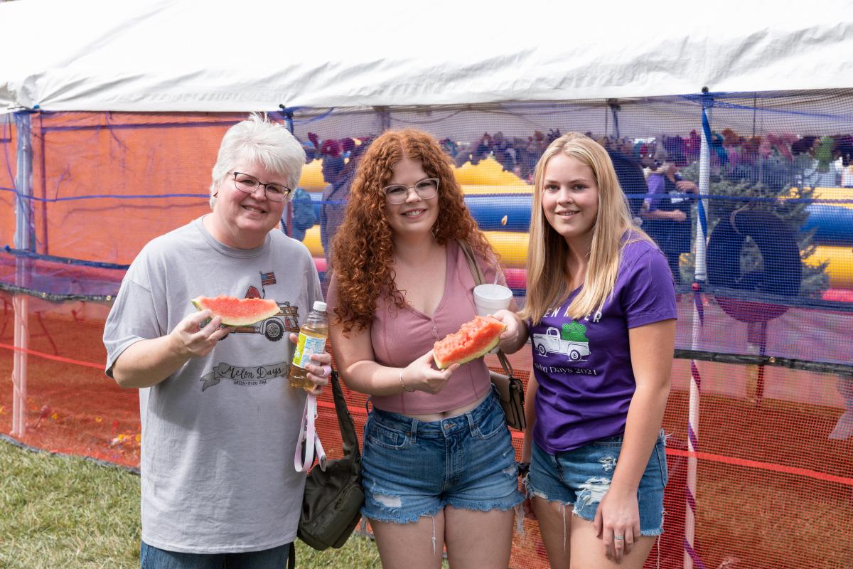 Three women eating watermelon slices