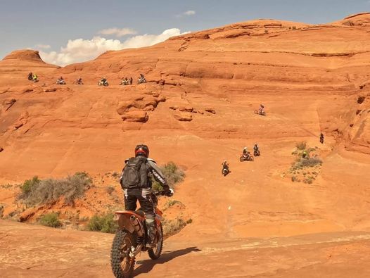 group of riders riding a trail