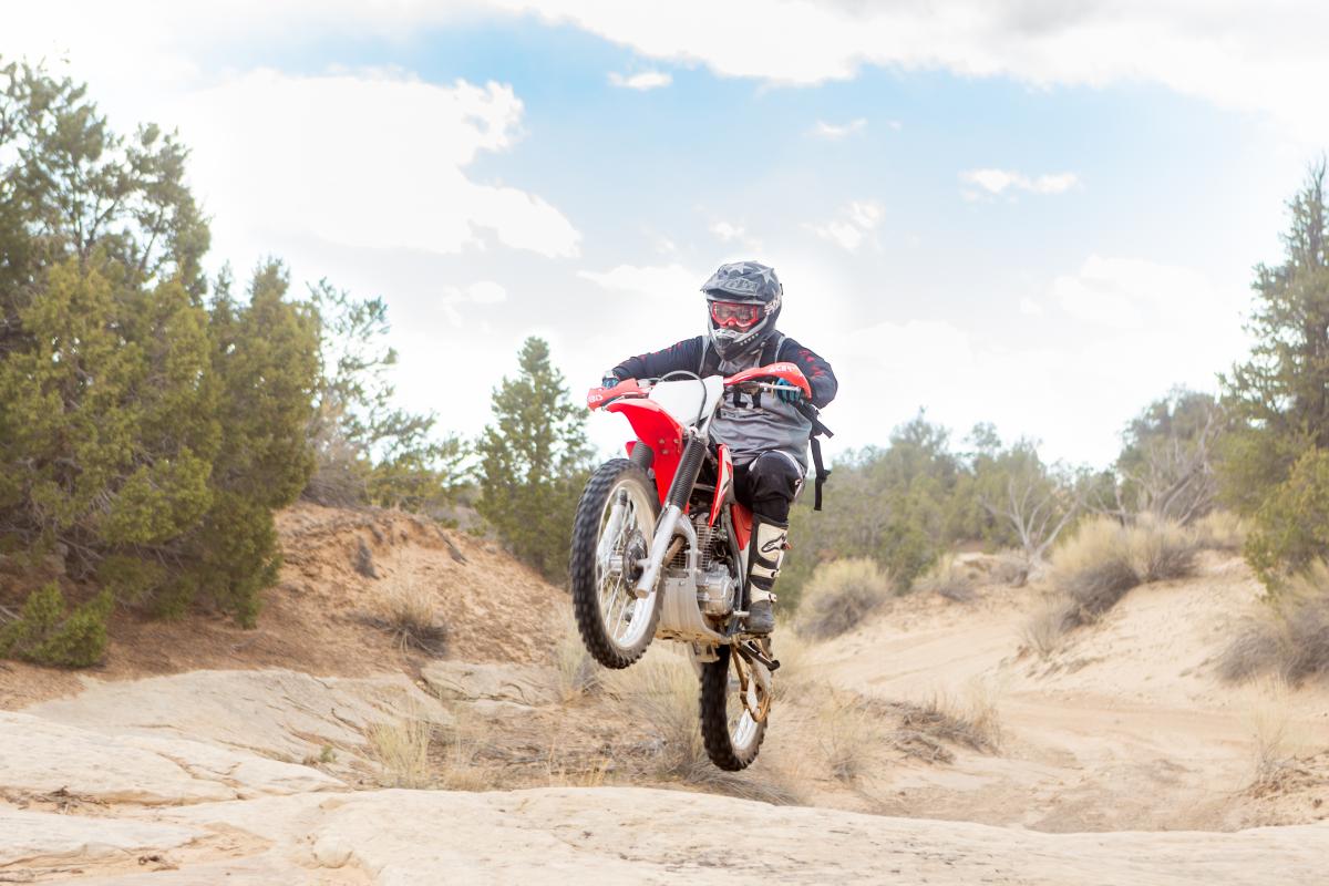 dirtbiker wheeling on trail