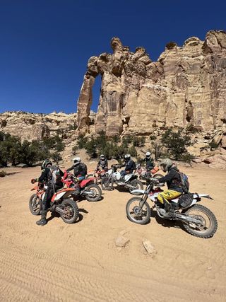 Group of Dirt Bikes and riders in front of arch