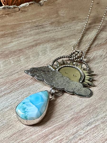 Statement celestial Larimar necklace. Large sun pendant peaking from out of the clouds with a beautiful dangling Larimar raindrop necklace picture