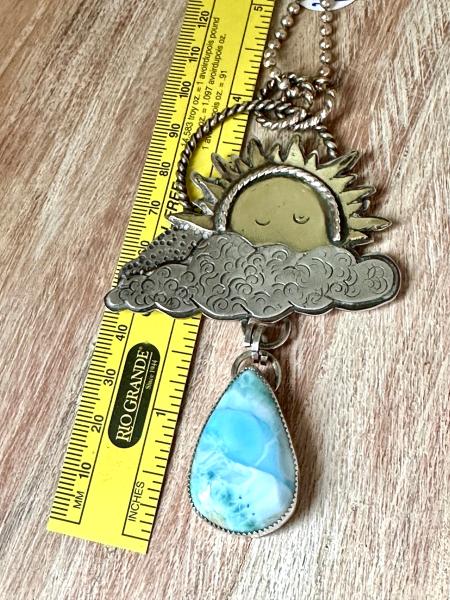 Statement celestial Larimar necklace. Large sun pendant peaking from out of the clouds with a beautiful dangling Larimar raindrop necklace picture