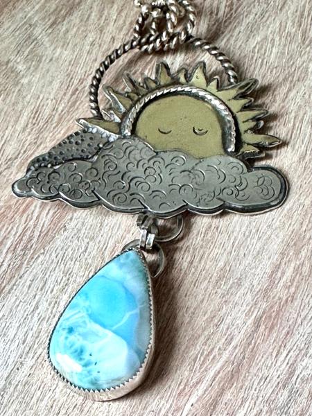 Statement celestial Larimar necklace. Large sun pendant peaking from out of the clouds with a beautiful dangling Larimar raindrop necklace picture