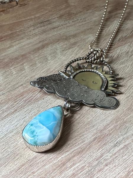 Statement celestial Larimar necklace. Large sun pendant peaking from out of the clouds with a beautiful dangling Larimar raindrop necklace picture