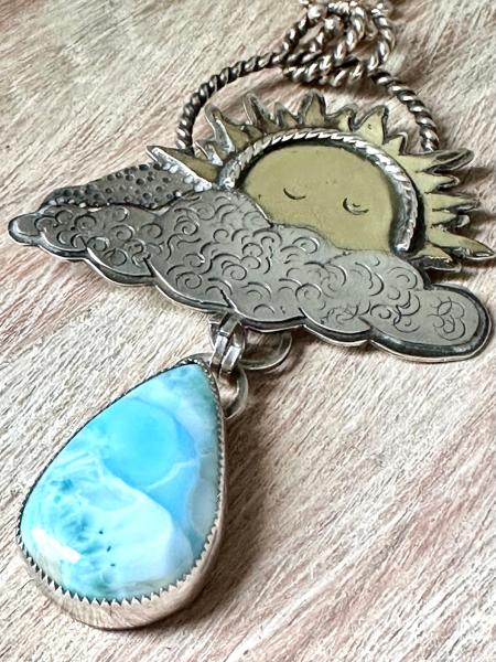 Statement celestial Larimar necklace. Large sun pendant peaking from out of the clouds with a beautiful dangling Larimar raindrop necklace picture