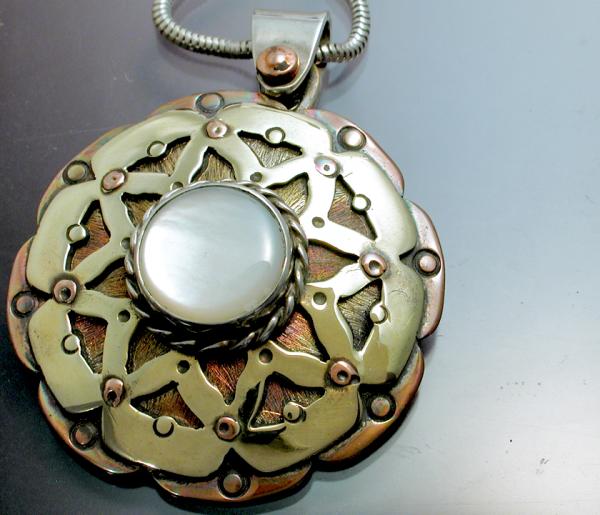 A mixed metal Mandala with mother of pearl