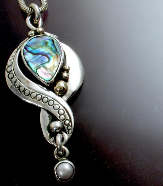 A silver and gold pendant with Abalone & Pearl